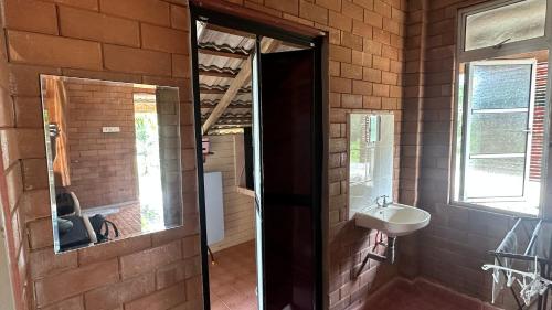 a bathroom with a sink and a mirror at Homestay Sani in Tanah Merah