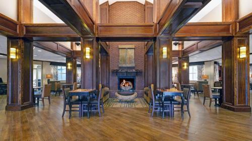 a room with tables and chairs and a fireplace at Inn On The Parkway Pigeon Forge in Pigeon Forge