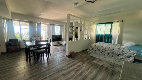 a bedroom with a bed and a table and chairs at Casa Axhé Rosarito in Rosarito Beach