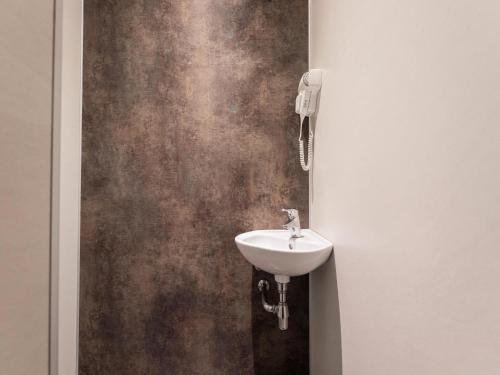 a bathroom with a sink and a wall at Cottage in Dwingelderveld with Scenic Views in Beilen