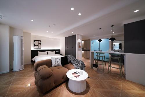 a living room with a couch and a bed at Funx设计师民宿 in Chengdu