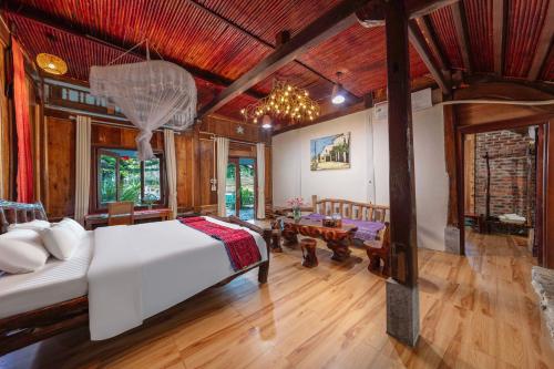 a bedroom with a bed and a living room at The Nordic Village - Evergreen Retreat in Mộc Châu