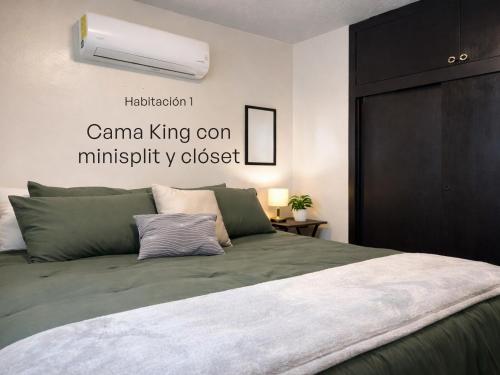 a bedroom with a bed with a black cabinet at Casa Pradera in Manuel F. Martínez