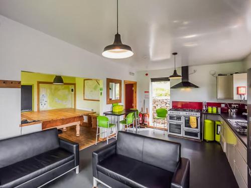 a living room with a couch and a kitchen with a table at The Bunkhouse - Uk50470 in Greenhaugh