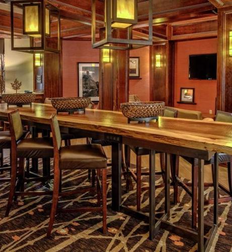 a dining room with a large wooden table and chairs at Inn On The Parkway Pigeon Forge in Pigeon Forge