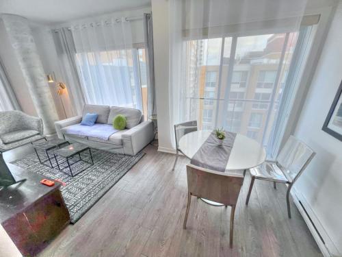 a living room with a couch and a table at The Downtown Zando in Montreal