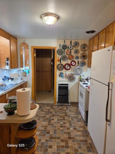 a kitchen with a white refrigerator and a sink at Gary's Place in Springfield