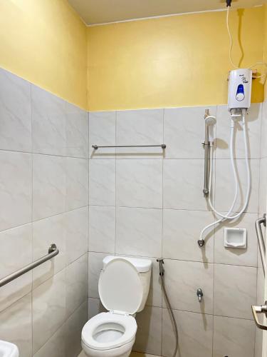 a bathroom with a toilet and a shower at Olive Suites in Cagayan de Oro