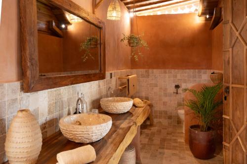 a bathroom with two sinks on a wooden counter at Taman Jati in Gili Islands