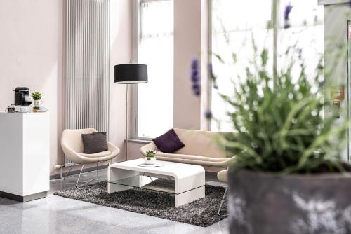 a living room with a couch and a coffee table at elaya hotel wolfenbuettel, Trademark Collection by Wyndham in Wolfenbüttel