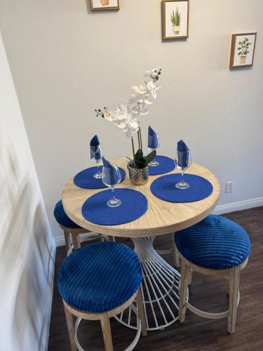 a wooden table with blue plates and blue chairs at Mario, Disney & not themed Loft Universal Studios 10min loft apartment in Los Angeles