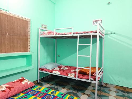 a room with two bunk beds in a room at Shanti Rental And Dormitory in Kāthgodām