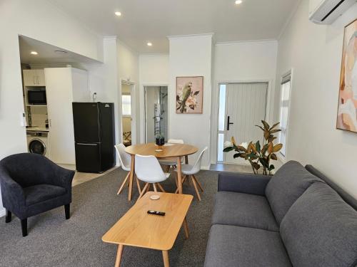 a living room with a couch and a table at Redwood Apartments in Rotorua