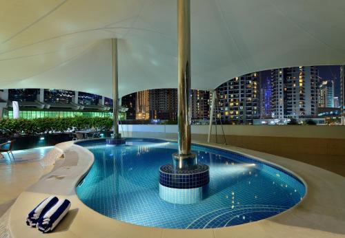 a swimming pool in a building with a city skyline at Oaks Liwa Heights Hotel Suites in Dubai
