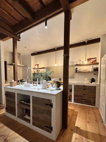 a large kitchen with a large white counter top at Locanda L`altra Cucina in Yokosuka