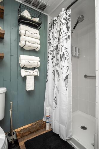 a bathroom with a shower curtain and towels at Valley View Hideaway Cabin with Mountain Views in Miramonte