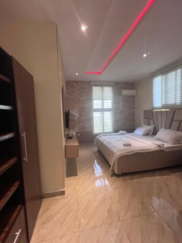 a bedroom with a bed with a red light on the ceiling at Lekki Waterfront Terrace shortlet with Oceanview, Attendants and private Jetty in Lagos