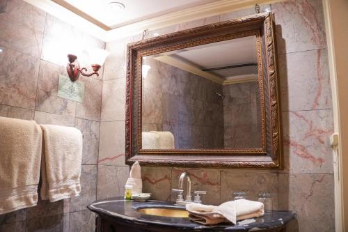 a bathroom with a sink and a mirror at The Olivier House Hotel in New Orleans