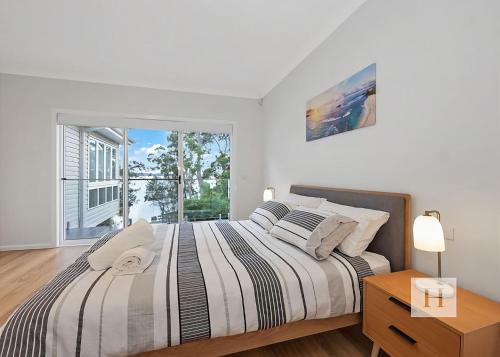 a bedroom with a large bed and a window at Angels Little Haven in Cams Wharf