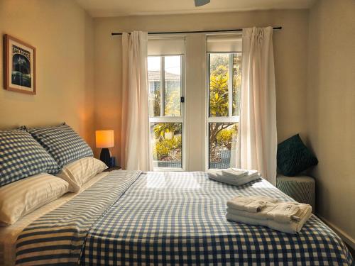 a bedroom with a bed and a window at Summer Villa in Kiama