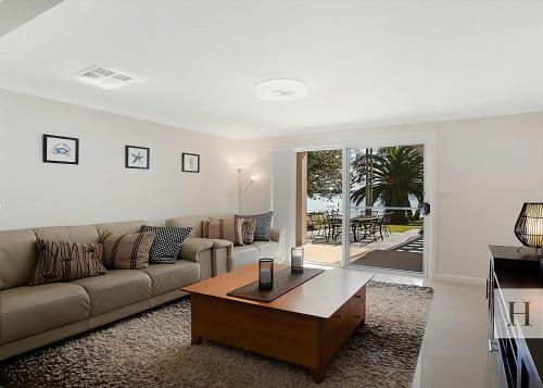 a living room with a couch and a coffee table at Enjoy Lazy Daze in Summerland Point