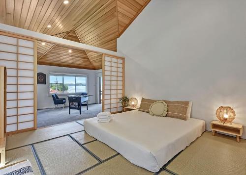 a bedroom with a large bed and a dining room at Lake Daze at Coal Point in Coal Point