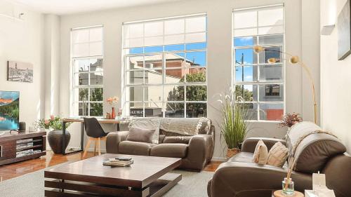 a living room with a couch and a table at New York Style Apartment in Bendigo
