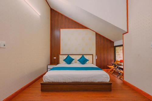 a bedroom with a large bed with blue pillows at Bong's House Sapa in Sapa