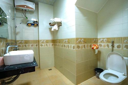a bathroom with a toilet and a sink at Bong's House Sapa in Sapa