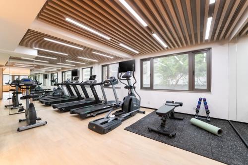a gym with a row of treadmills and exercise machines at Kew Green Hotel Wanchai Hong Kong in Hong Kong