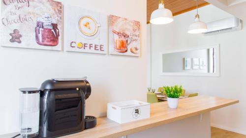 a kitchen with a counter with a coffee machine on it at Praça 44 in Braga