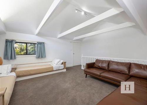 a living room with a couch and a window at Lakeshores Villa in Cams Wharf