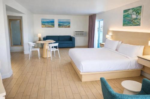 a hotel room with a bed and a couch at Chateau Mar Beach Hotel NEWLY REFURBISHED in Ormond Beach