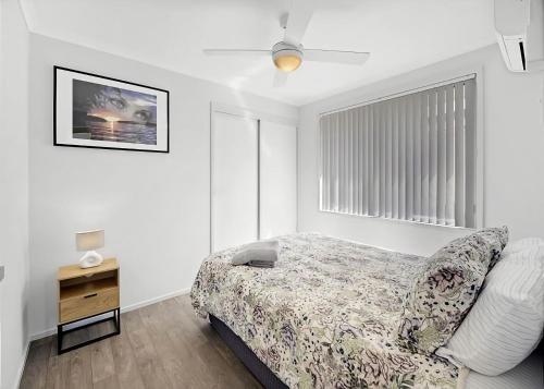 a bedroom with a bed and a dresser and a window at The Sailor s Haven in Mannering Park