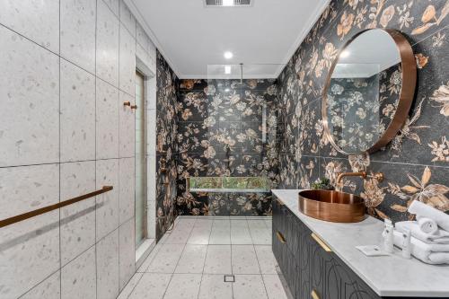 a bathroom with a sink and a mirror at The Hideaway Currumbin in Gold Coast