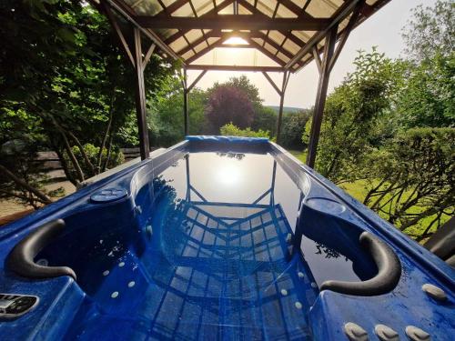 a blue plunge pool in a gazebo at Panoráma Villa Vágáshuta in Vágáshuta
