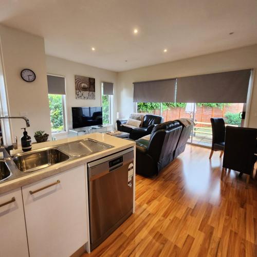 a kitchen and living room with a couch and a table at Lbarza Charming Central 2BR Townhouse in Shepparton