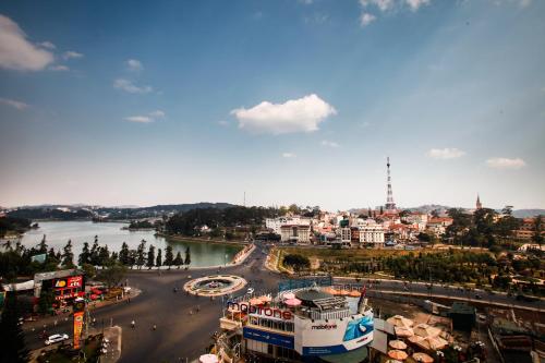 a view of a city with a river and buildings at TTC Hotel - Ngoc Lan in Da Lat
