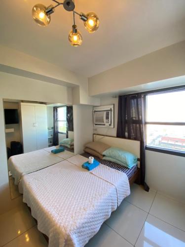 a bedroom with a bed with two bowls on it at Carlota247 in Cebu City