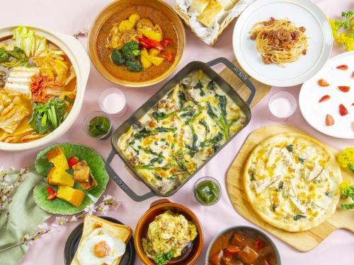 a table with many different dishes of food on it at Sapporo View Hotel Odori Park in Sapporo