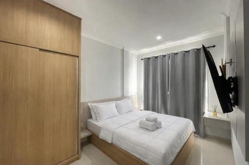 a bedroom with a bed with a pillow on it at Sanur House Lavender in Sanur