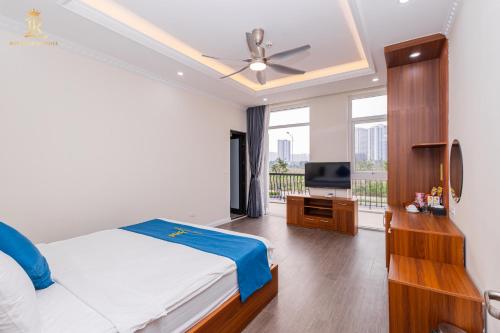 a bedroom with a bed and a flat screen tv at Khách sạn đẹp Hà Nội - Royal Louis Hotel in Dại Mõ