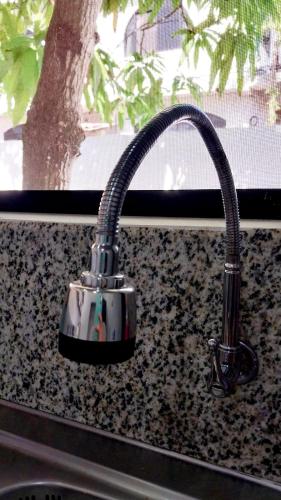 a kitchen sink faucet on a granite counter top at Genovesa Family home in Puerto Ayora