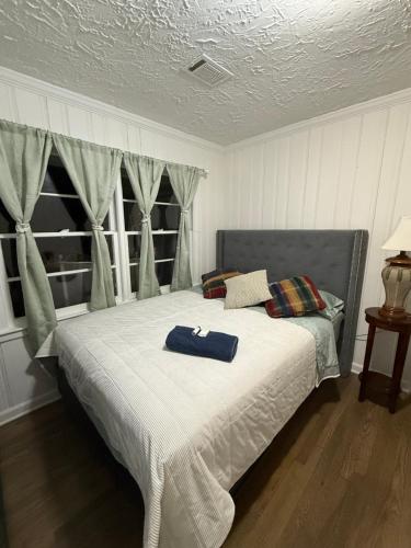 a bedroom with a bed with a blue towel on it at April Palace green in Decatur