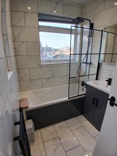 a bathroom with a sink and a window at Victoria Guest Apartment in Ramsgate