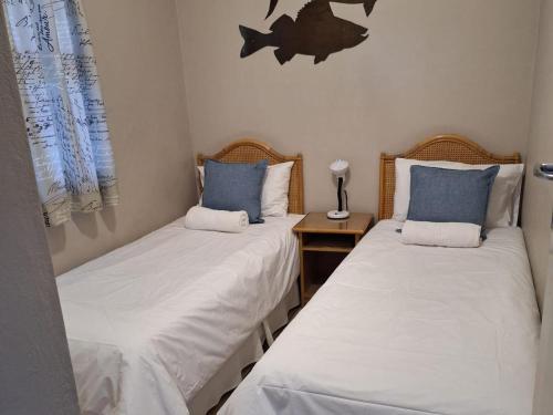 two beds sitting next to each other in a room at The Estuary Guest Chalets in St Lucia