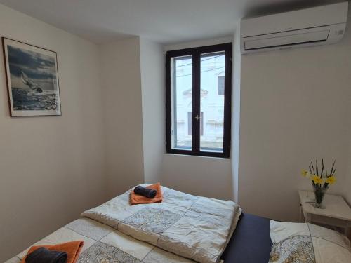 a bedroom with a bed and a window at ReginaMare Santa in Piran