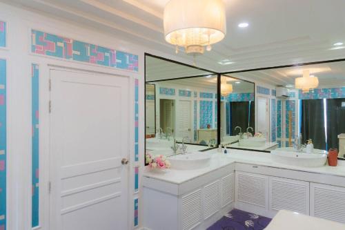 a bathroom with two sinks and a large mirror at Private Pool Party Villa games Karaoke, in Nonthaburi