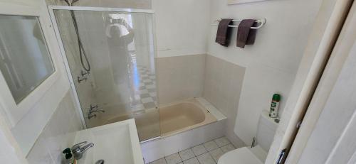 a bathroom with a shower and a tub and a toilet at Gloucester View in Gloucester