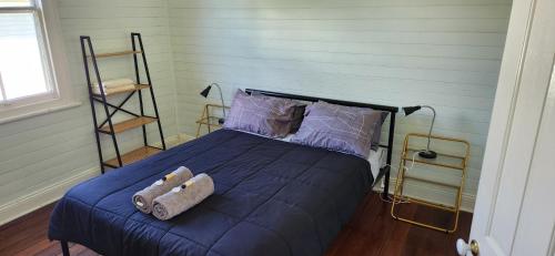 a bedroom with a bed with towels on it at Gloucester View in Gloucester